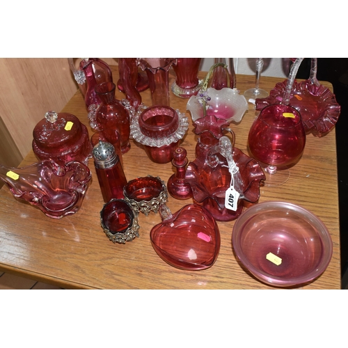 407 - A COLLECTION OF TWENTY-SIX CRANBERRY GLASS ITEMS to include a pair of wine glasses, three baskets (o... 