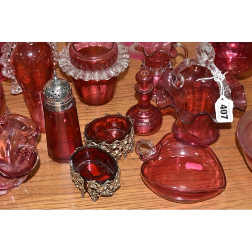 407 - A COLLECTION OF TWENTY-SIX CRANBERRY GLASS ITEMS to include a pair of wine glasses, three baskets (o... 