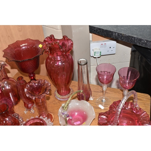 407 - A COLLECTION OF TWENTY-SIX CRANBERRY GLASS ITEMS to include a pair of wine glasses, three baskets (o... 