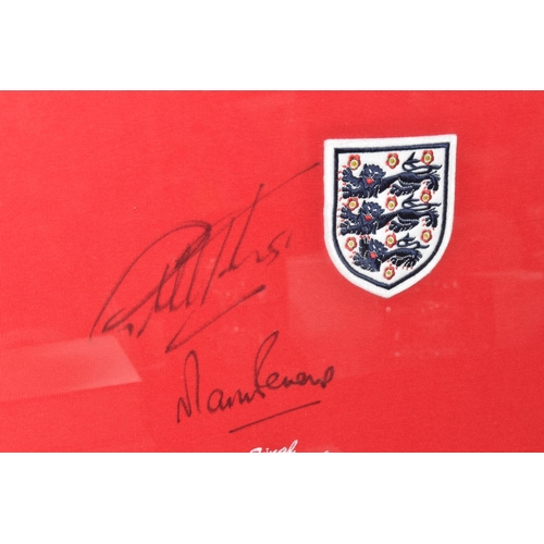 444 - A FRAMED REPLICA ENGLAND SHIRT, SIGNED BY GEOFF HURST AND MARTIN PETERS, to commemorate the 1966 Wor... 