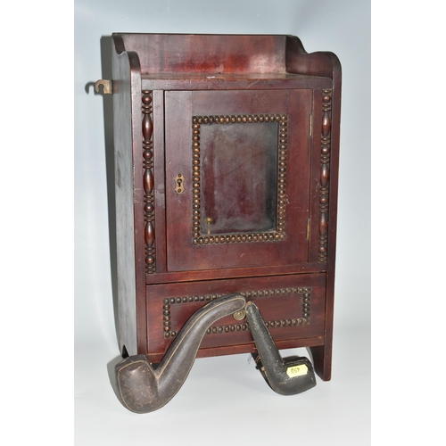 450 - A MAHOGANY SMOKERS CABINET, wall-mountable or free standing, the glazed door opens to reveal two pip... 