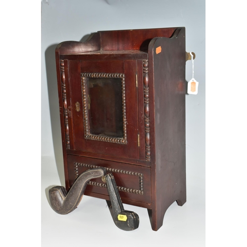 450 - A MAHOGANY SMOKERS CABINET, wall-mountable or free standing, the glazed door opens to reveal two pip... 