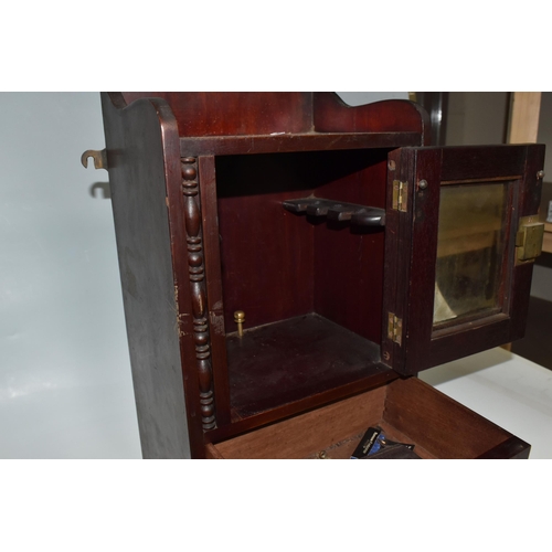 450 - A MAHOGANY SMOKERS CABINET, wall-mountable or free standing, the glazed door opens to reveal two pip... 