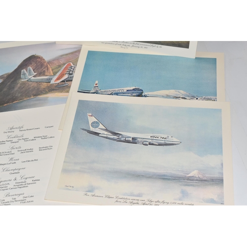 460 - A COMPLETE SET OF THIRTEEN PAN AM FIRST CLASS MENUS, illustrated by John T. McCoy and depicting a hi... 