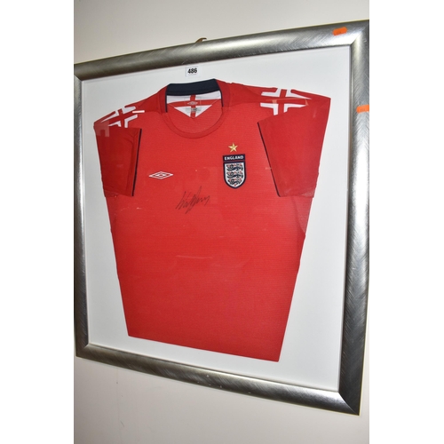 486 - A FRAMED ENGLAND FOOTBALL SHIRT, bearing signature, an official Umbro product red England Away footb... 