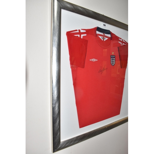 486 - A FRAMED ENGLAND FOOTBALL SHIRT, bearing signature, an official Umbro product red England Away footb... 