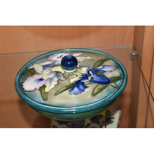 373 - A MOORCROFT POTTERY 'ORCHID' PATTERN COVERED BOWL, tube lined with blue and purple orchids on a grad... 