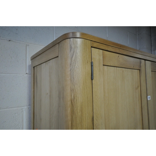 151 - AN OAK FURNITURE LAND ROMSEY NATURAL SOLID OAK LARGE LARDER, with two sets of double doors, the top ... 