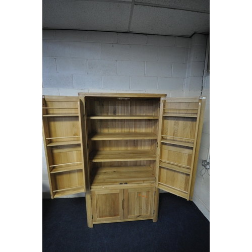 151 - AN OAK FURNITURE LAND ROMSEY NATURAL SOLID OAK LARGE LARDER, with two sets of double doors, the top ... 