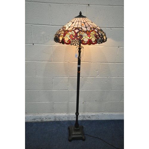 155 - A PAIR OF TIFFANY STYLE STANDARD LAMPS, the shade with coloured scrolled details, the pillar support... 