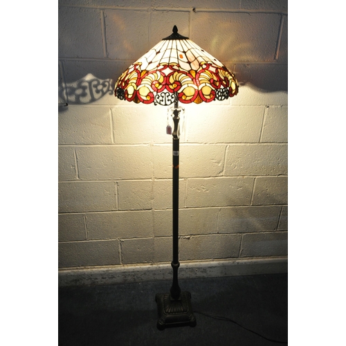 155 - A PAIR OF TIFFANY STYLE STANDARD LAMPS, the shade with coloured scrolled details, the pillar support... 