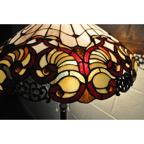 155 - A PAIR OF TIFFANY STYLE STANDARD LAMPS, the shade with coloured scrolled details, the pillar support... 