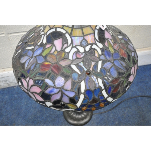 156 - A TIFFANY STYLE TABLE LAMP, the shade with foliate details, of various colours, raised on a shaped s... 