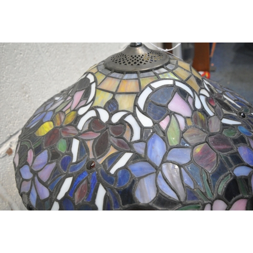 156 - A TIFFANY STYLE TABLE LAMP, the shade with foliate details, of various colours, raised on a shaped s... 