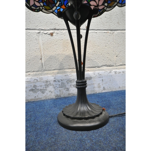 156 - A TIFFANY STYLE TABLE LAMP, the shade with foliate details, of various colours, raised on a shaped s... 