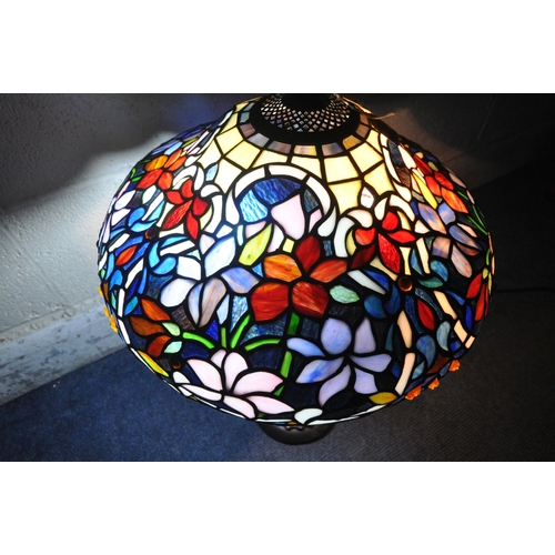 156 - A TIFFANY STYLE TABLE LAMP, the shade with foliate details, of various colours, raised on a shaped s... 