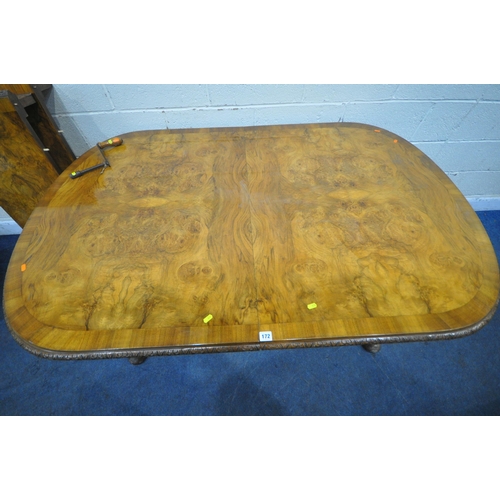 172 - A BURR WALNUT OVAL WIND OUT DINING TABLE, with two additional leaves, raised on cabriole legs, exten... 