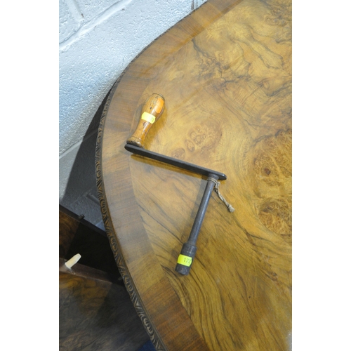 172 - A BURR WALNUT OVAL WIND OUT DINING TABLE, with two additional leaves, raised on cabriole legs, exten... 