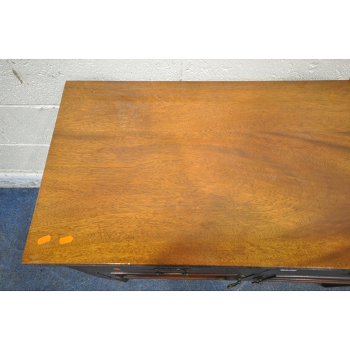 187 - AN EARLY 20TH CENTURY MAHOGANY CABINET, fitted with two drawers, above double cupboard doors, raised... 