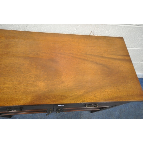 187 - AN EARLY 20TH CENTURY MAHOGANY CABINET, fitted with two drawers, above double cupboard doors, raised... 