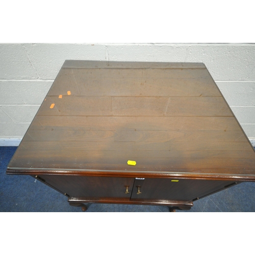 191 - A LATE 20TH CENTURY MAHOGANY DOUBLE DOOR CUPBOARD, with a glass protective surface, raised on cabrio... 