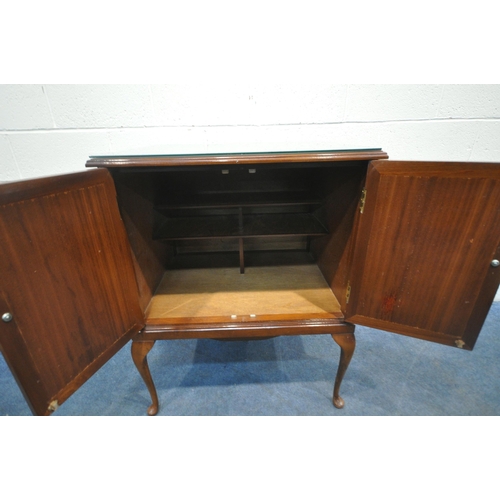 191 - A LATE 20TH CENTURY MAHOGANY DOUBLE DOOR CUPBOARD, with a glass protective surface, raised on cabrio... 