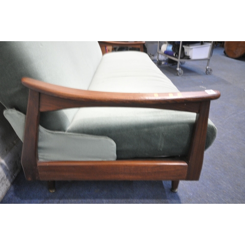 193 - A MID CENTURY TEAK FRAME SOFA BED, with green fabric upholstery, swept open armrests raised on taper... 