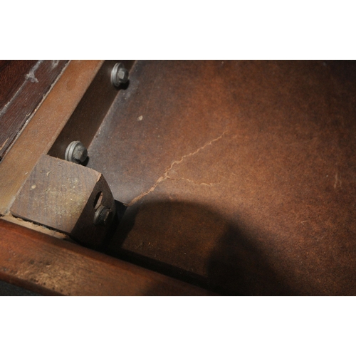 193 - A MID CENTURY TEAK FRAME SOFA BED, with green fabric upholstery, swept open armrests raised on taper... 