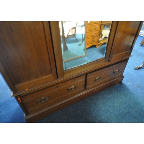 196 - AN EARLY 20TH CENTURY WARDROBE, with two foliate panels, flanking a bevelled mirror door, above two ... 