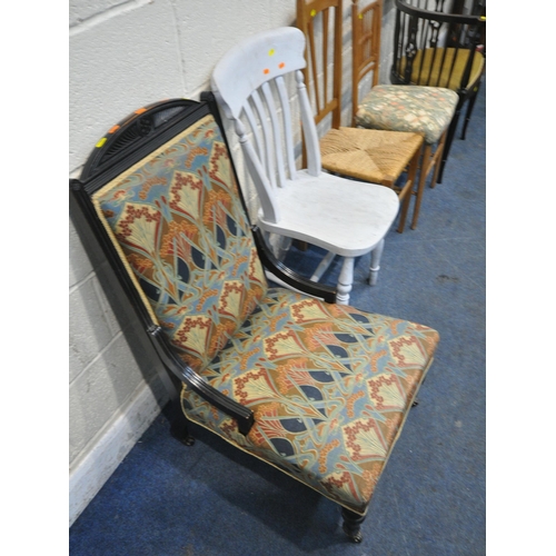 201 - A 20TH CENTURY EBONISED CHAIR, with patterned upholstery, raised on turned front legs, a bow top arm... 