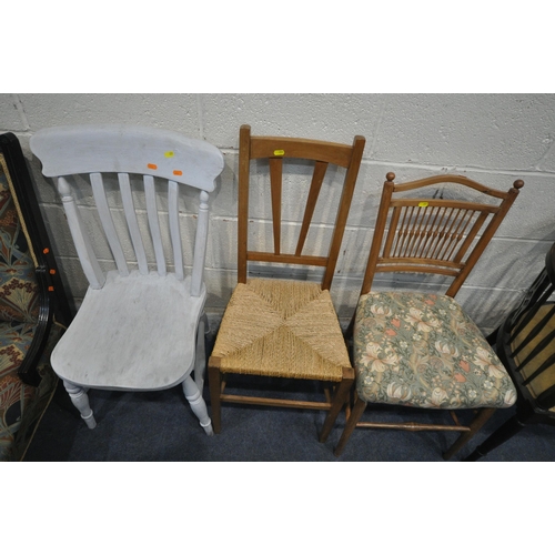 201 - A 20TH CENTURY EBONISED CHAIR, with patterned upholstery, raised on turned front legs, a bow top arm... 