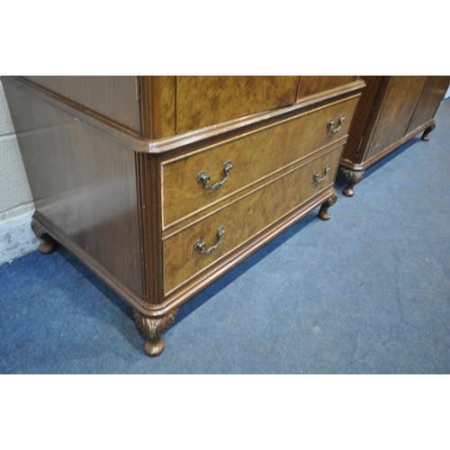 213 - TWO 20TH CENTURY QUEEN ANNE STYLE WALNUT DOUBLE DOOR WARDROBES, with foliate crests, raised on small... 