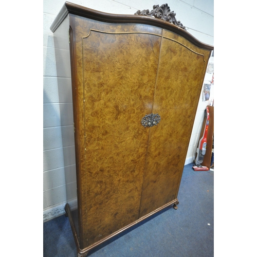 213 - TWO 20TH CENTURY QUEEN ANNE STYLE WALNUT DOUBLE DOOR WARDROBES, with foliate crests, raised on small... 