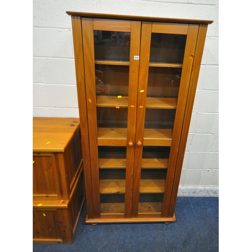 215 - THREE PIECES OF MODERN PINE FURNITURE, to include a bookcase, with two glass doors, width 87cm x dep... 