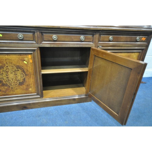 221 - A 20TH CENTURY MAHOGANY AND WALNUT BREAKFRONT BOOKCASE, fitted with four bevelled glass doors, atop ... 