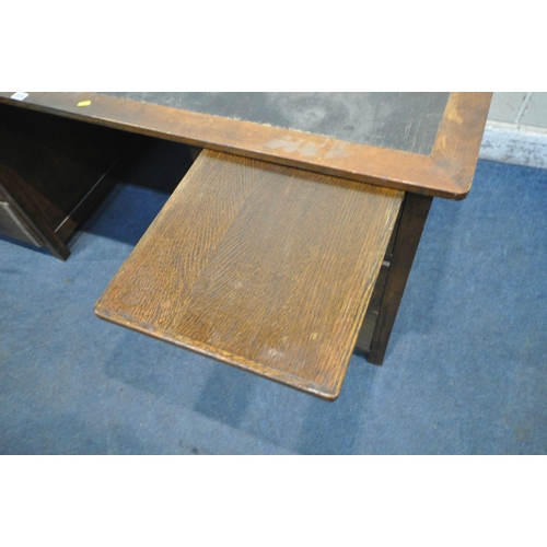 228 - A LARGE 20TH CENTURY OAK DESK, with one brushing slide, and six drawers, width 183cm x depth 107cm x... 