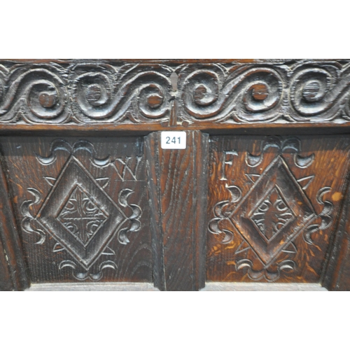 241 - A GEORGIAN OAK COFFER, with a hinged lid, the four front panels with geometric designs, width 128cm ... 