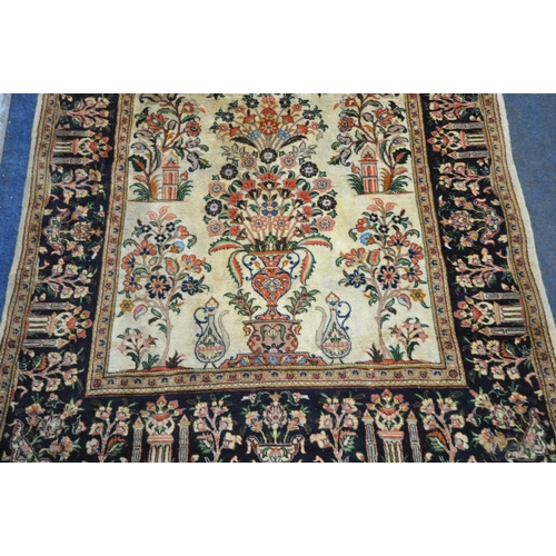 242 - A CREAM GROUND RECTANGULAR PERSIAN ISFAHAN RUG, with temples and foliate design, 204cm x 137cm, cond... 