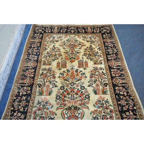 242 - A CREAM GROUND RECTANGULAR PERSIAN ISFAHAN RUG, with temples and foliate design, 204cm x 137cm, cond... 