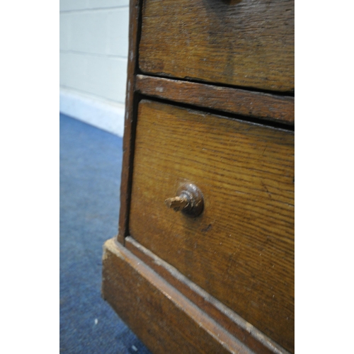 244 - A 20TH CENTURY OAK TWIN PEDESTAL DESK, with an oxblood leather writing surface, fitted with nine ass... 