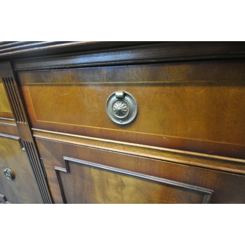 252 - A REPRODUCTION MAHOGANY BREAKFRONT SIDEBOARD, fitted with four drawers, above four cupboard doors, r... 