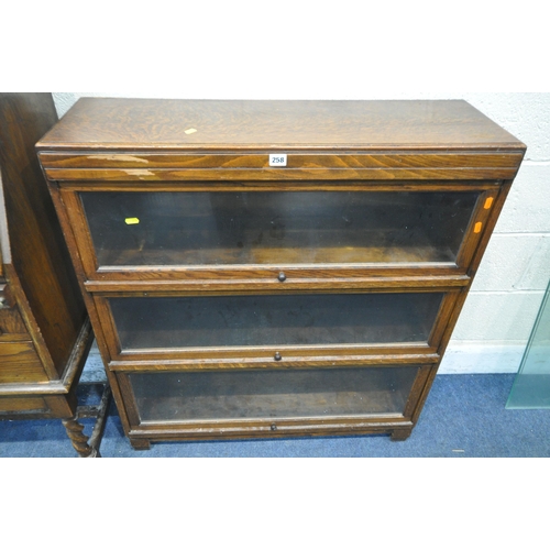 258 - A 20TH CENTURY OAK BOOKCASE, with three hide and fall glass doors, width 90cm x depth 29cm x height ... 