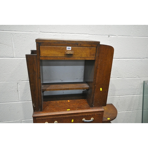 265 - AN ART DECO OAK SIDE TABLE, with a double sided drawer, shelves to one end, and a magazine rack to t... 