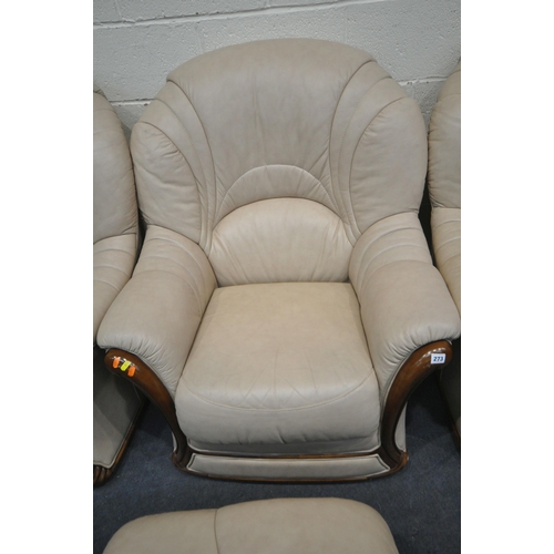 273 - A SET OF THREE CREAM LEATHER ARMCHAIRS, along with a matching footstool, condition report: in need o... 