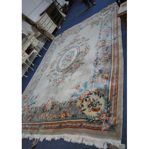 277 - A LARGE CREAM GROUND CHINESE RUG, with a central design, repeating patterns, 379cm x 274cm, conditio... 