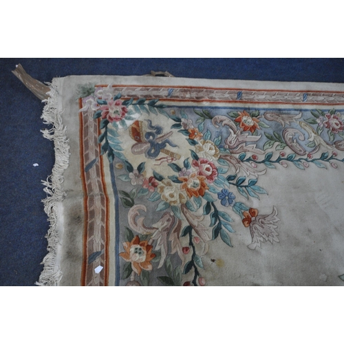 277 - A LARGE CREAM GROUND CHINESE RUG, with a central design, repeating patterns, 379cm x 274cm, conditio... 