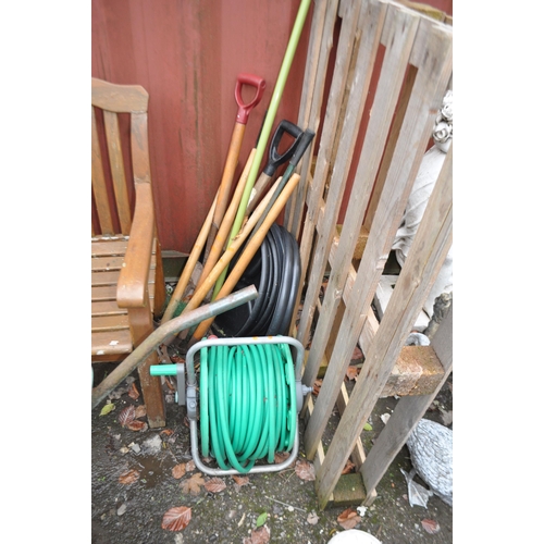 7 - A PLASTIC BUILDERS WHEELBARROW , four plastic dustbins with lids and a selection of garden tools