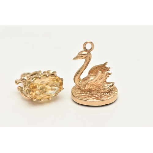 405 - TWO 9CT GOLD CHARMS, the first a swan shaped fob seal, set with a polished onyx inlay, hallmarked 9c... 