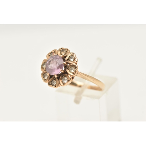 417 - A 9CT GOLD AMETHYST AND SPINEL FLORAL CLUSTER RING, set with a central circular cut amethyst, within... 