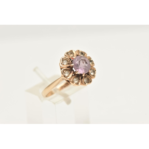 417 - A 9CT GOLD AMETHYST AND SPINEL FLORAL CLUSTER RING, set with a central circular cut amethyst, within... 